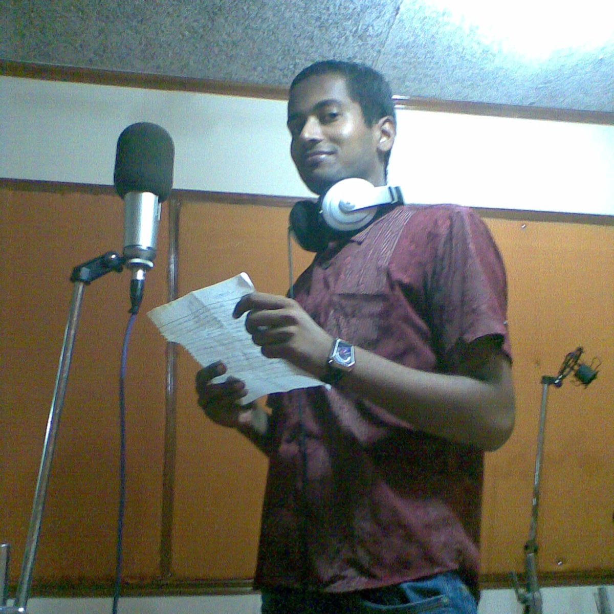 Reading from a script at a microphone, Maruti Suzuki years (first job)